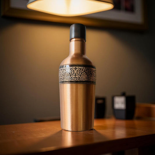 Decorative bottle with intricate design on a wooden surface, softly lit by a lamp.