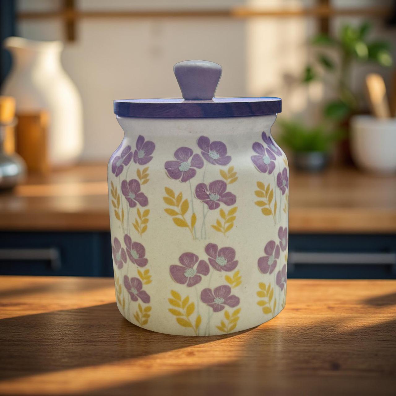 Ceramic jar with floral design and purple lid on a wooden surface
