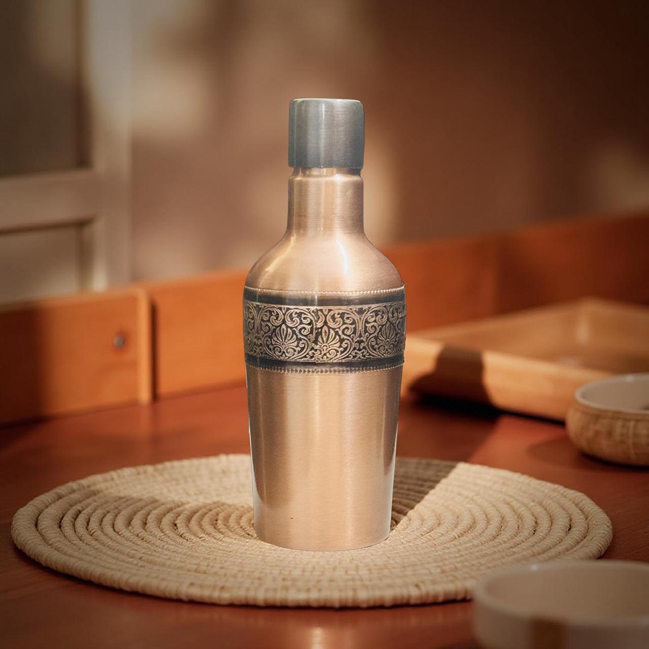 Silver shaker with decorative band on a woven mat on a wooden surface