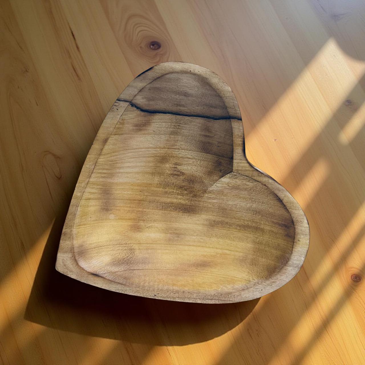 Heart-shaped wooden cutting board on a wooden surface