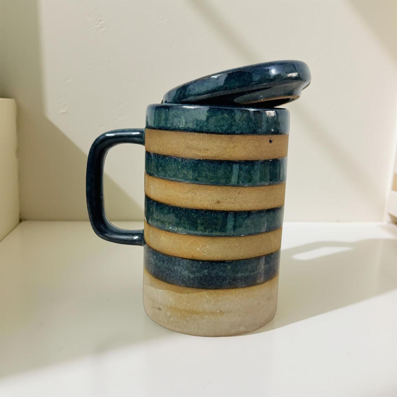 Ceramic mug with striped design on a white surface