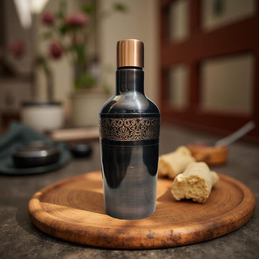 Decorative bottle with intricate design on a wooden surface in a blurred indoor setting