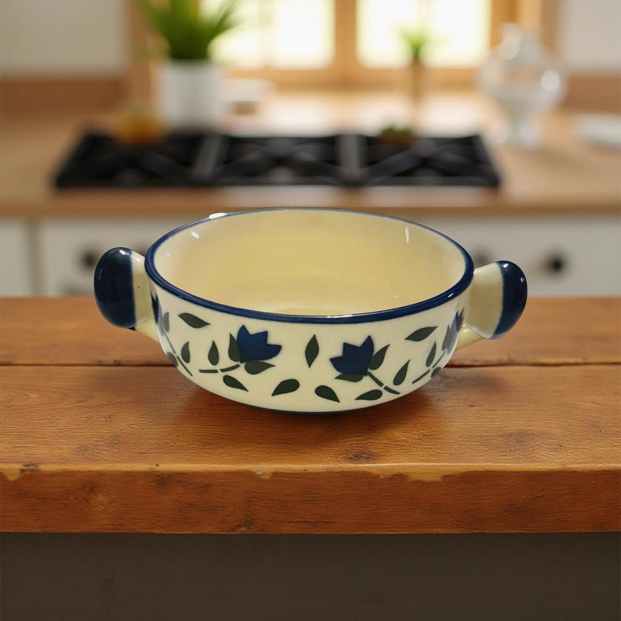Ceramic bowl with blue floral patterns on a wooden surface in a kitchen setting