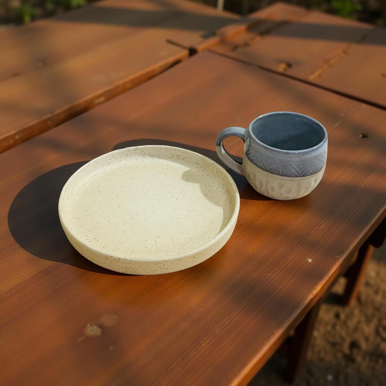 Ceramic plate and mug on a wooden surface
