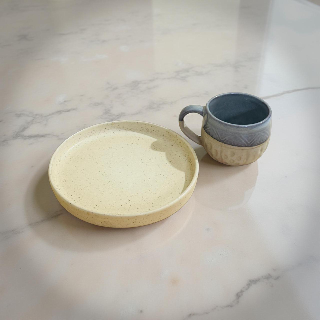 Ceramic plate and mug on a marble surface