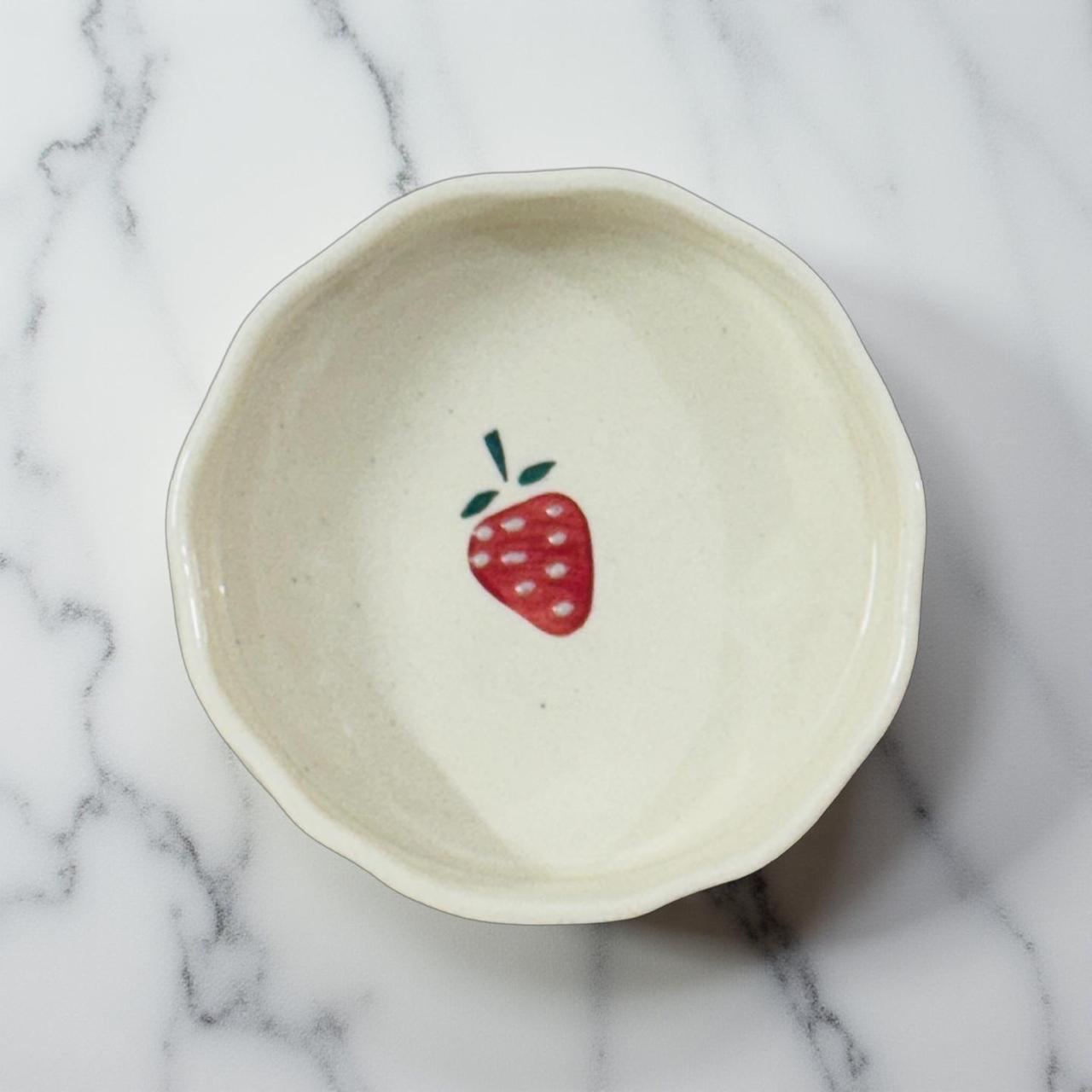 white ceramic serving bowl for fruits and small snacks on a white marble tile