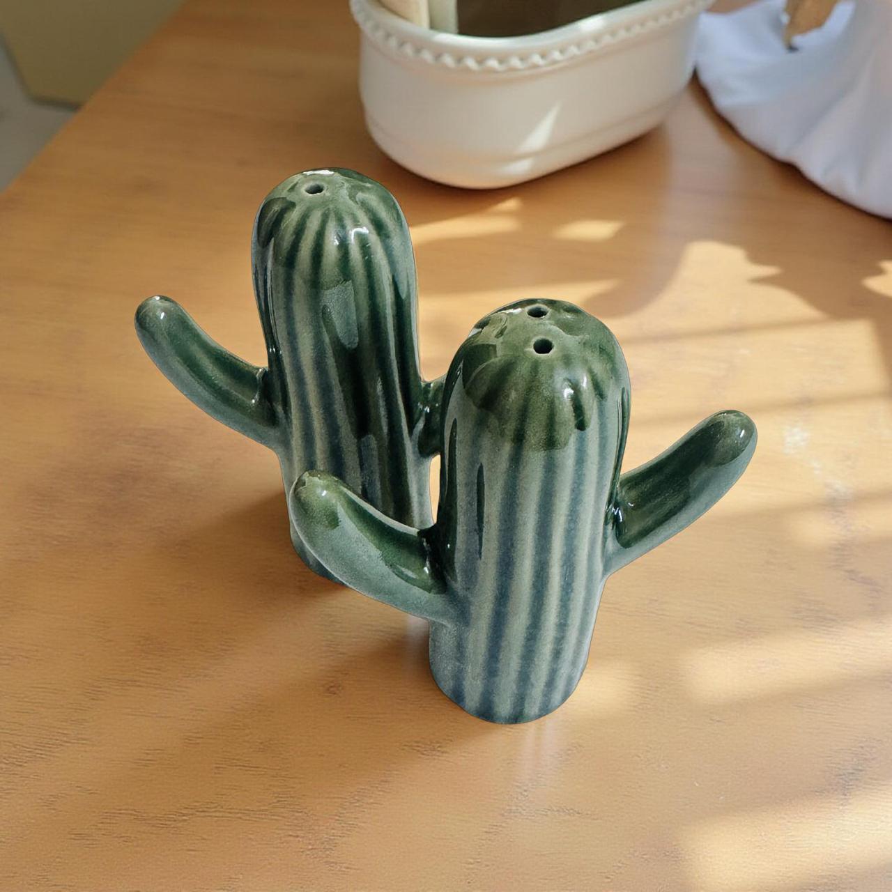 Ceramic cactus-shaped salt and pepper shaker on a wooden surface