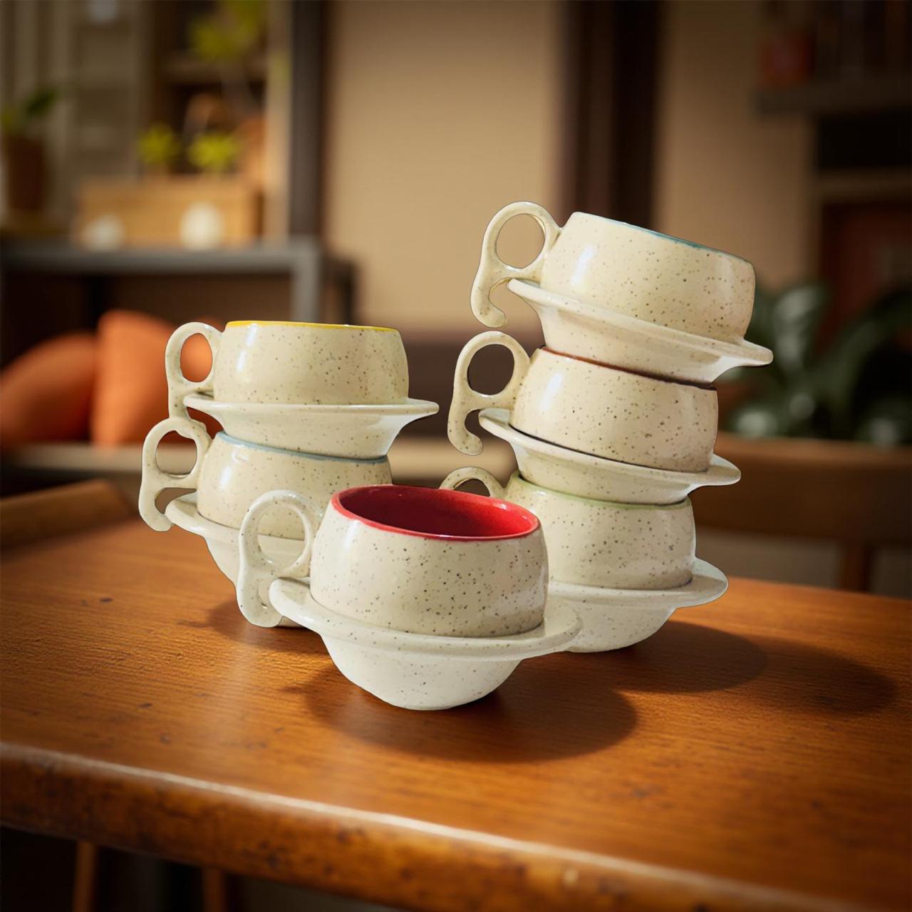 Set of ceramic cups and saucers on a wooden table