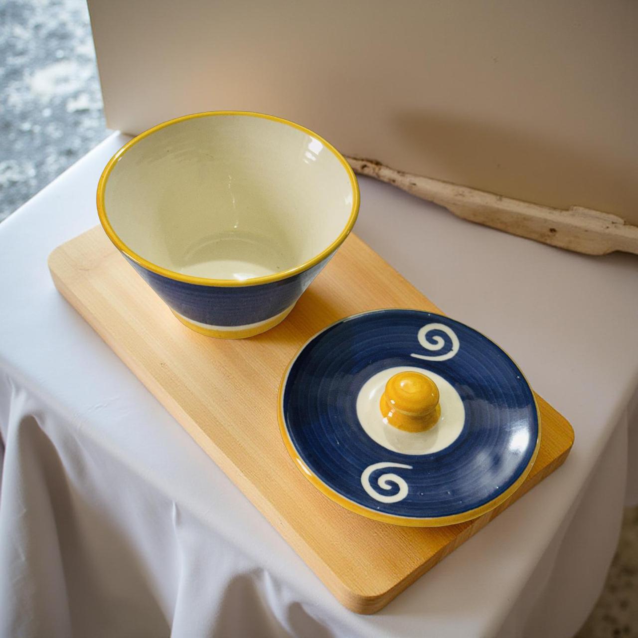 Ceramic bowl and plate with decorative design on a wooden board