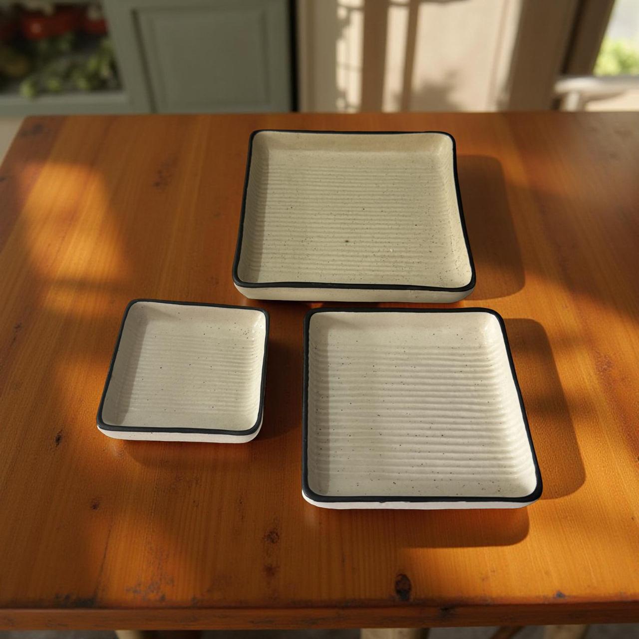 Three square filters on a wooden table
