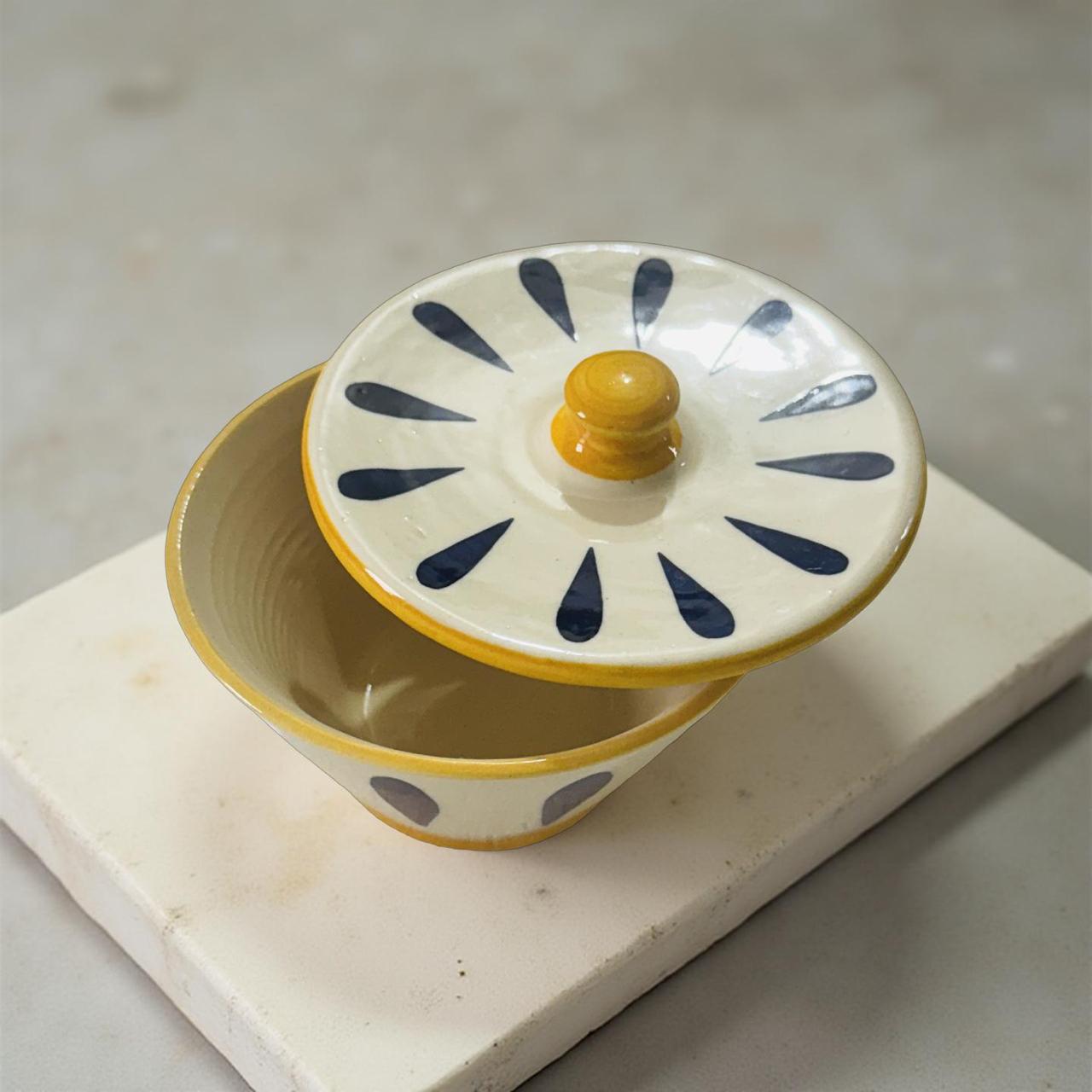 Ceramic container with a lid on a marble surface