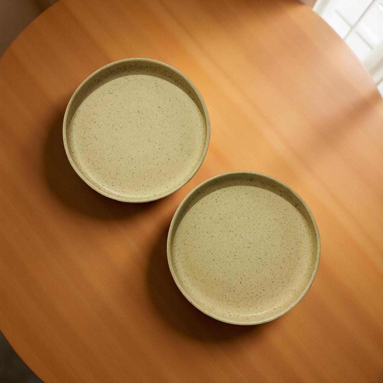 Two ceramic plates on a wooden surface