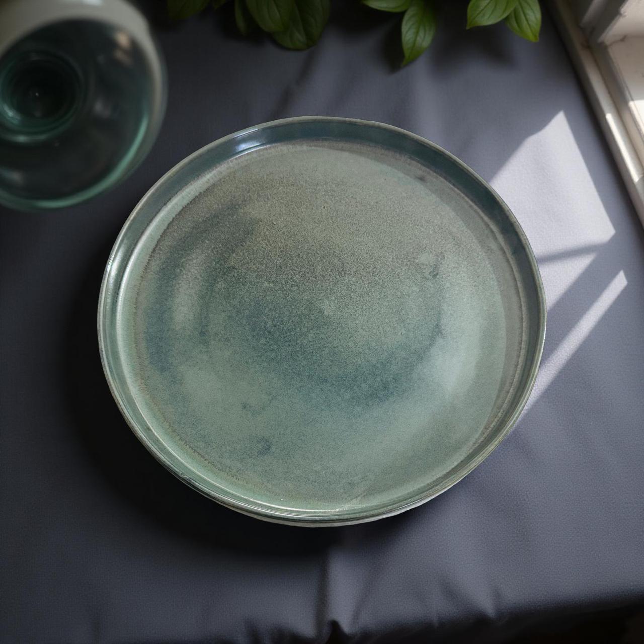 Green ceramic plate on a dark surface