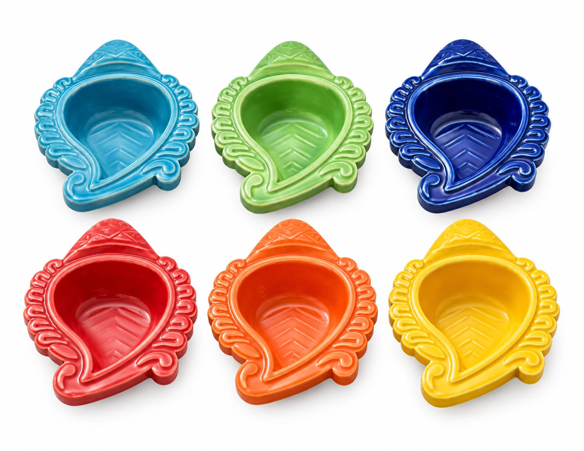 Six leaf-shaped ceramic oil lamps in different colors (blue, green, navy, red, orange, yellow) arranged in two rows on a white background.
