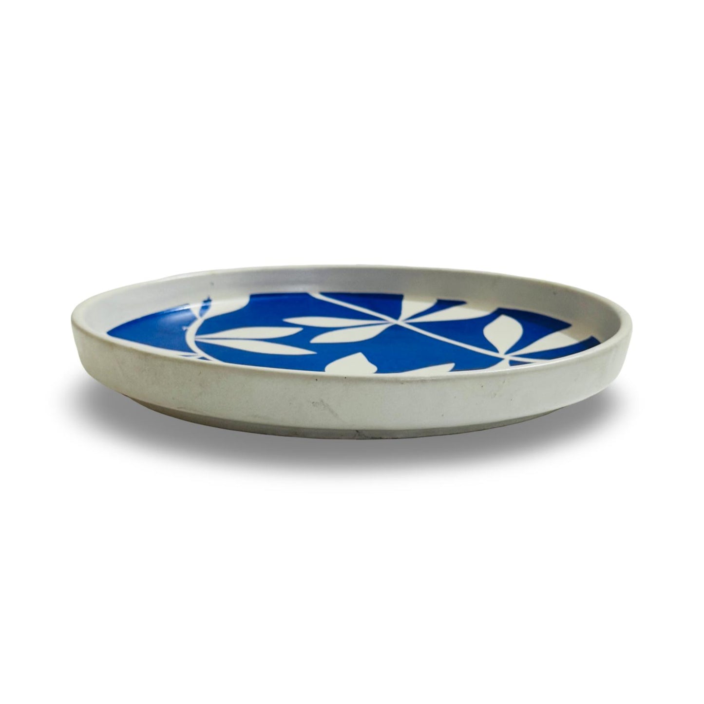 Round ceramic tray with blue floral design on a white background