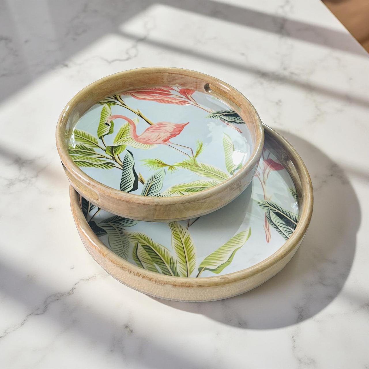 Two ceramic bowls with floral and flamingo design on a marble surface