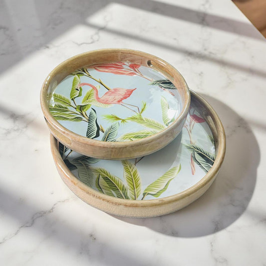 Two ceramic bowls with floral and flamingo design on a marble surface
