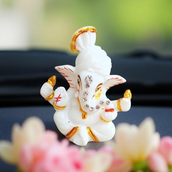 lord ganesha with gold and red accents on a blurred floral background