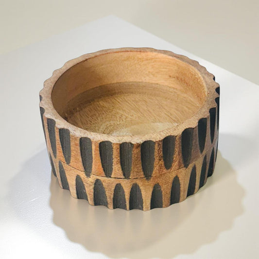 Wooden bowl with a geometric pattern on a white background