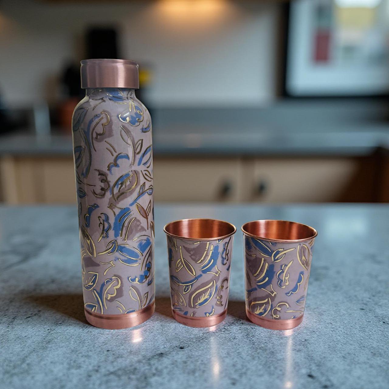 Copper-patterned bottle and cups on a kitchen counter