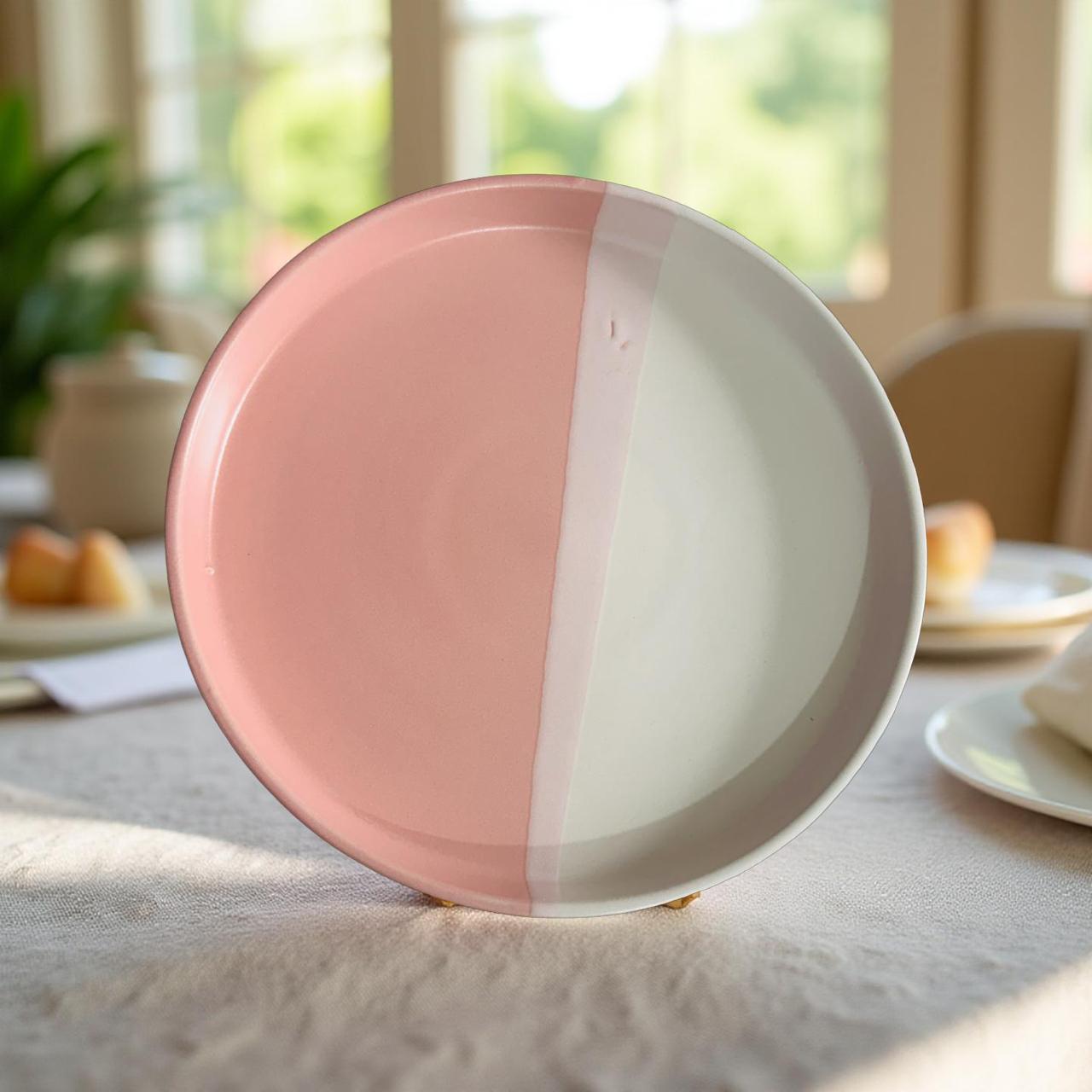 Pink and white ceramic plate on a table with a blurred background