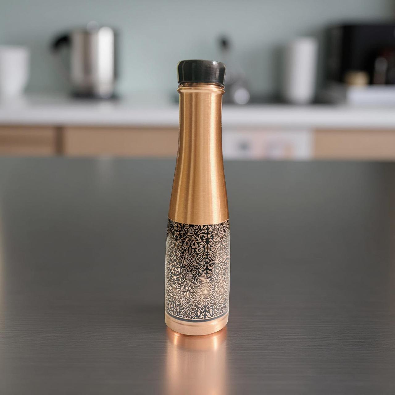 Decorative bottle with gold and black design on a kitchen counter