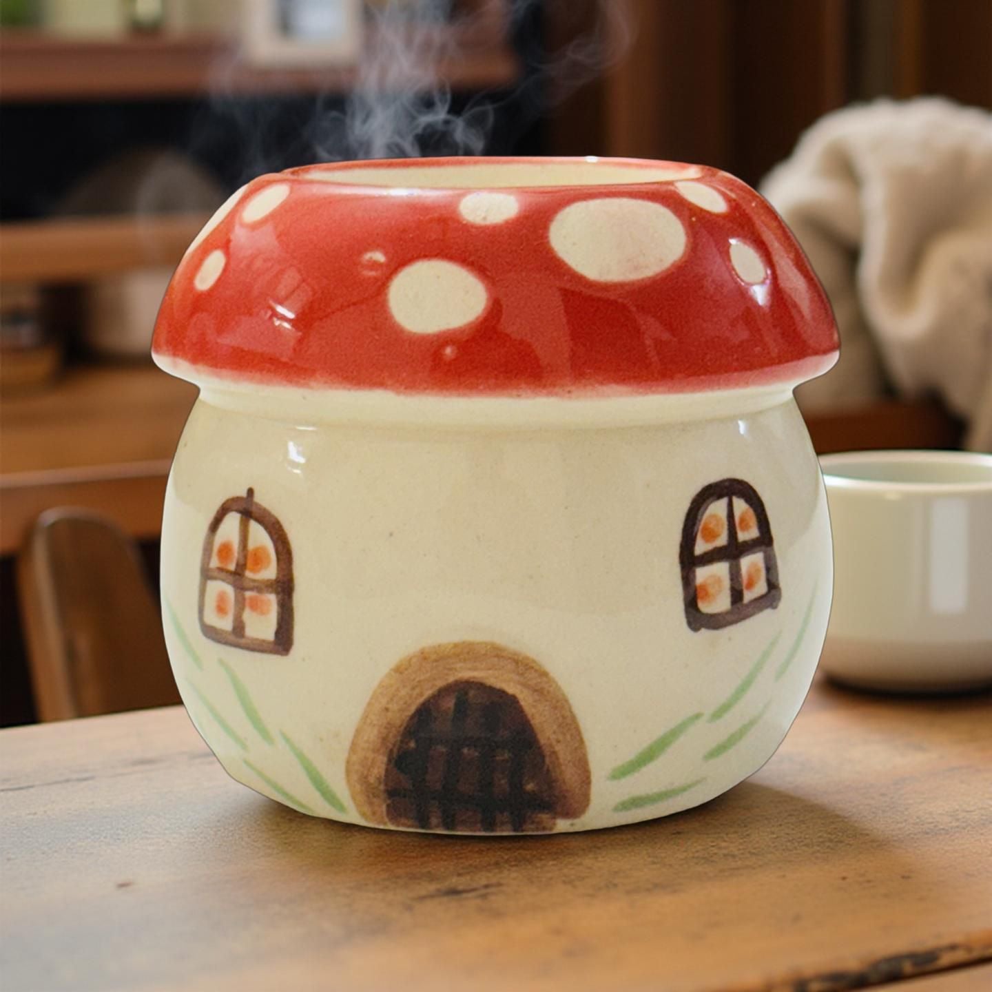 Ceramic mushroom-shaped container with a red cap on a wooden surface