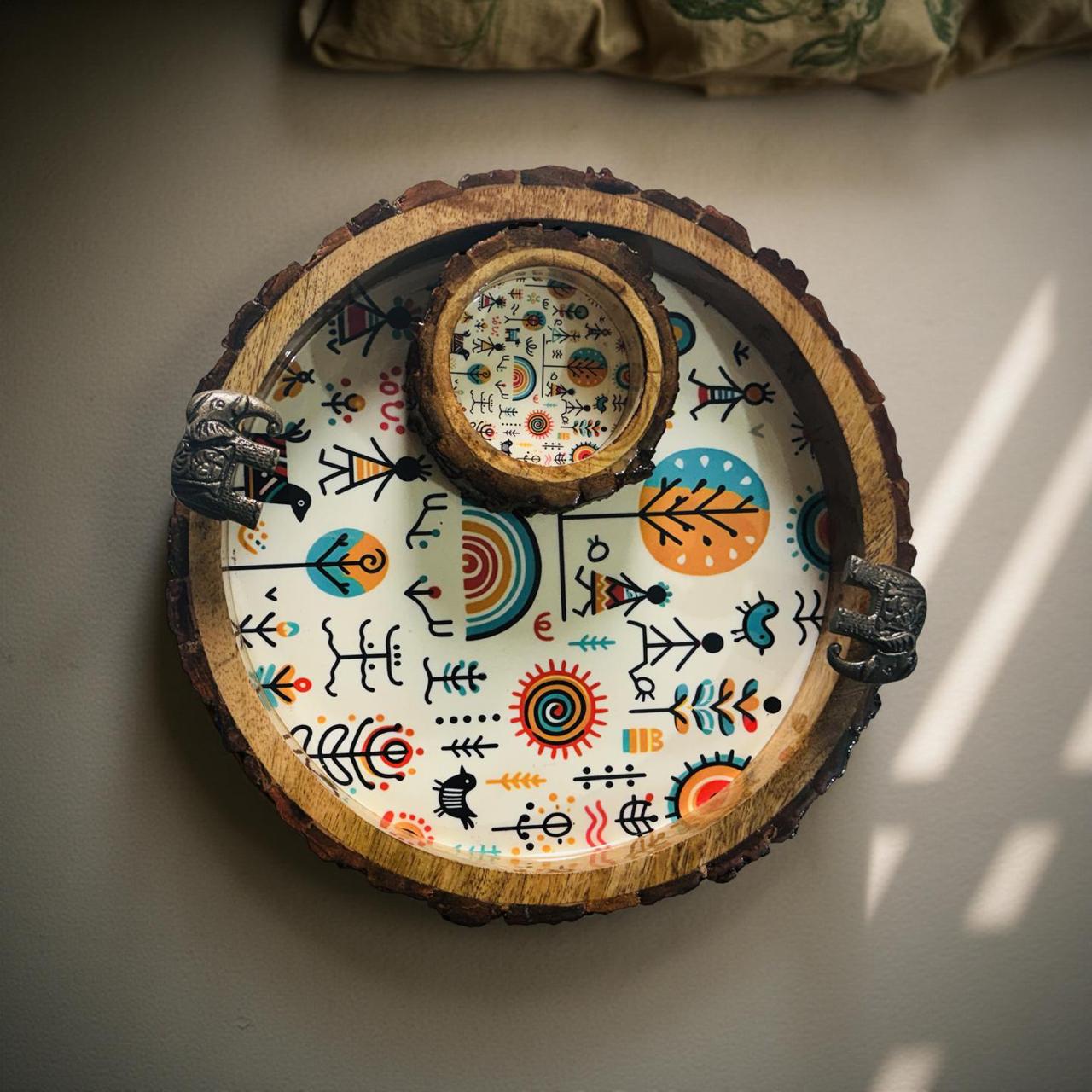 Decorative wooden tray with colorful patterns on a light surface