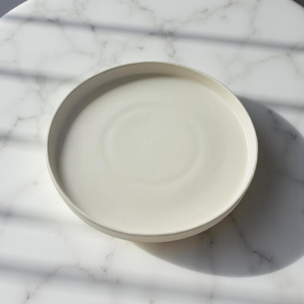 White ceramic bowl on a marble surface