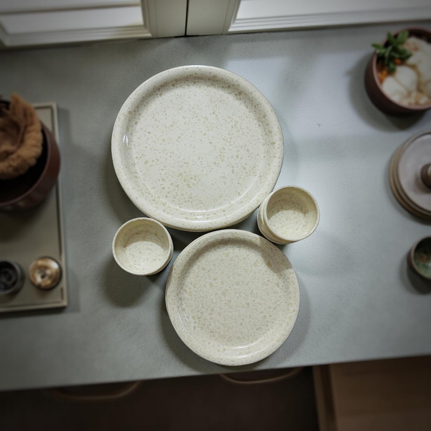Set of ceramic plates and bowls on a countertop