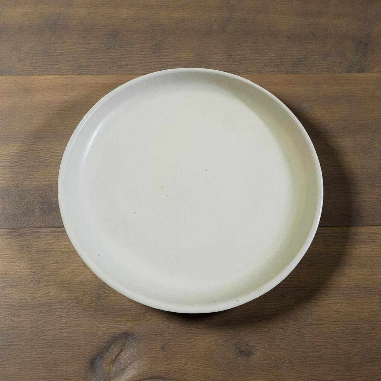 White ceramic plate on a wooden surface