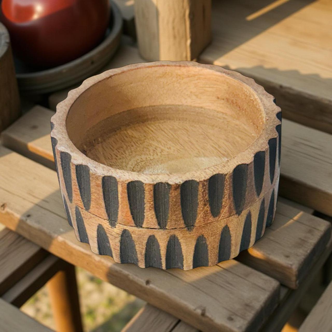 Wooden bowl with textured design on a wooden surface