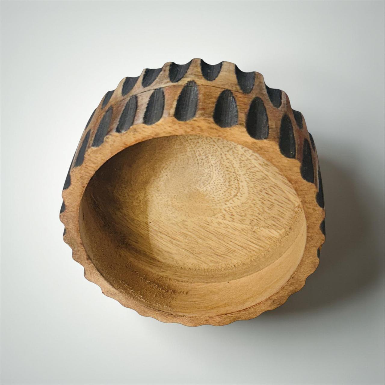 Wooden bowl with bear paw design on a white background