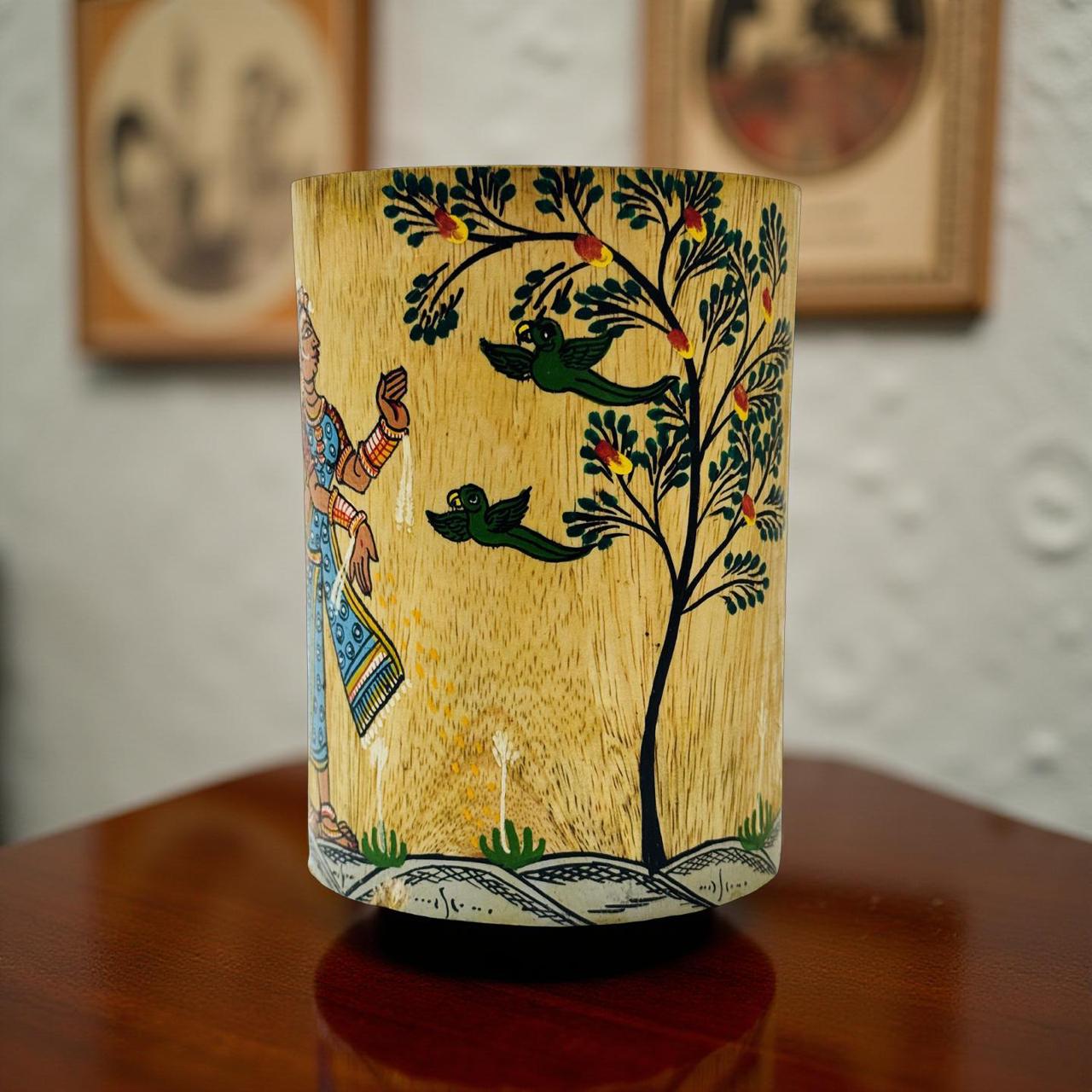 Decorative jar with hand-painted design on a wooden surface
