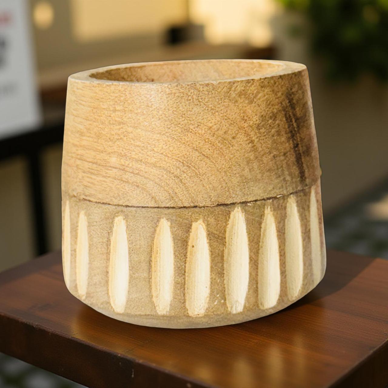 Wooden planter with decorative elements on a wooden surface