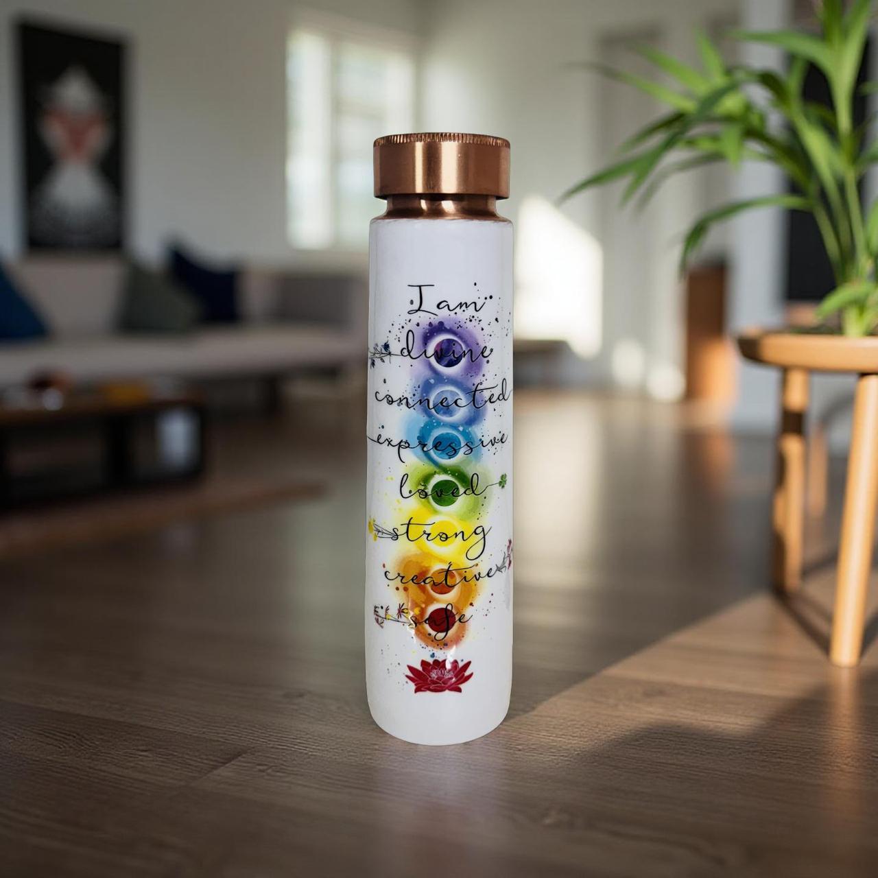 Water bottle with chakra design and motivational quote in a living room setting