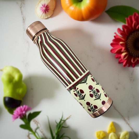Handcrafted copper water bottle with modern striped and floral print on wooden surface