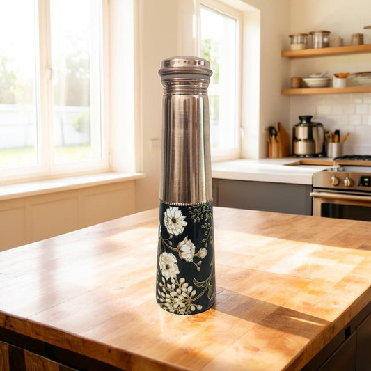 Decorative water bottle with floral design on a kitchen counter