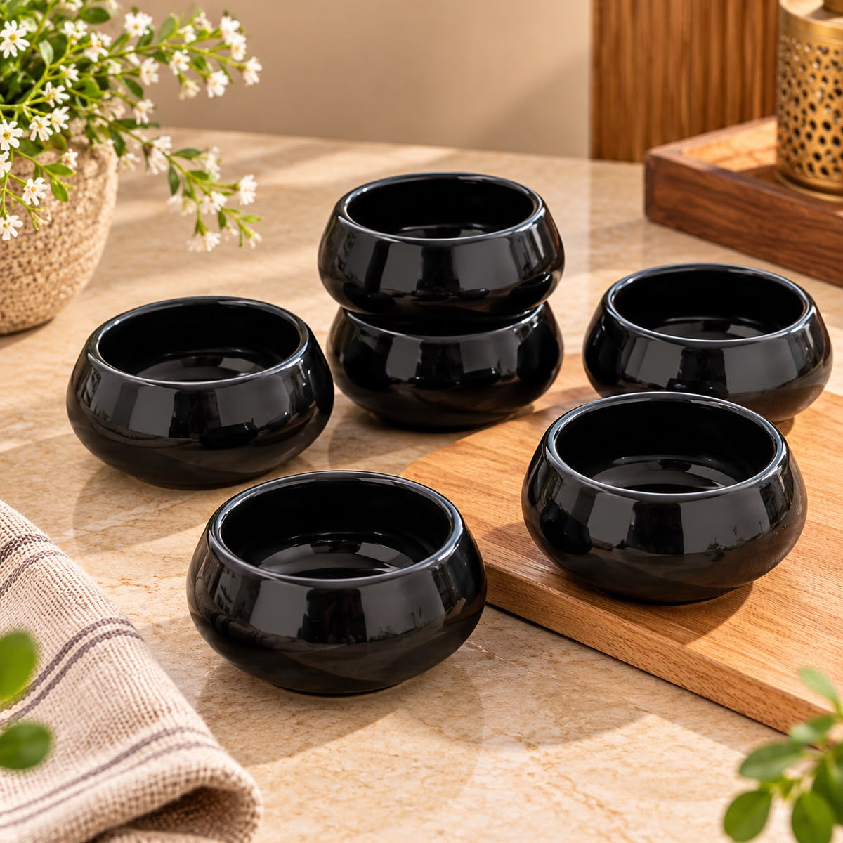 Black ceramic snack bowls with a reflective glazed finish for serving chutneys, dry fruits, dips and condiments.