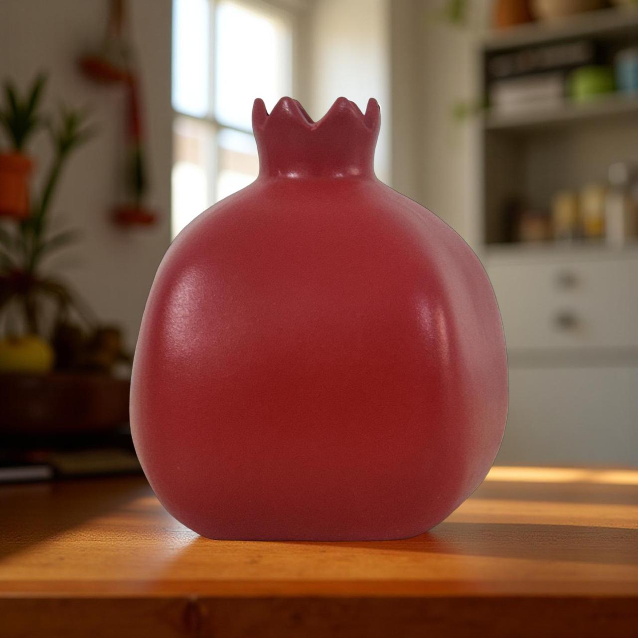 Modern artificial plant in red ceramic vase for home and office decor.