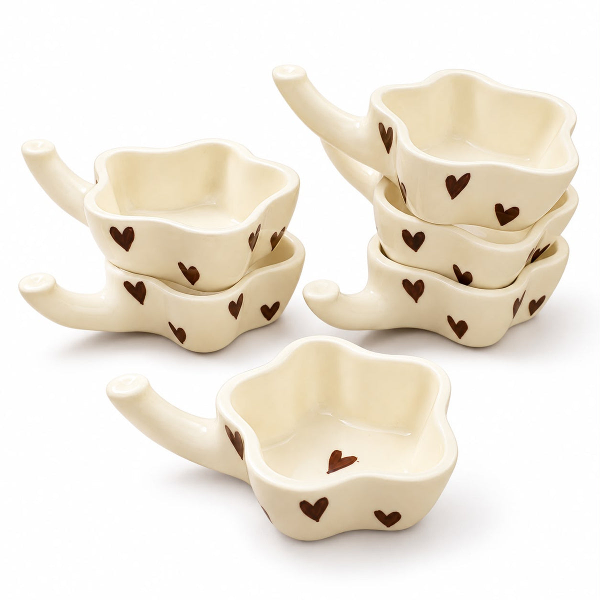 Heart motif ceramic condiment bowls arranged for Indian snack serving