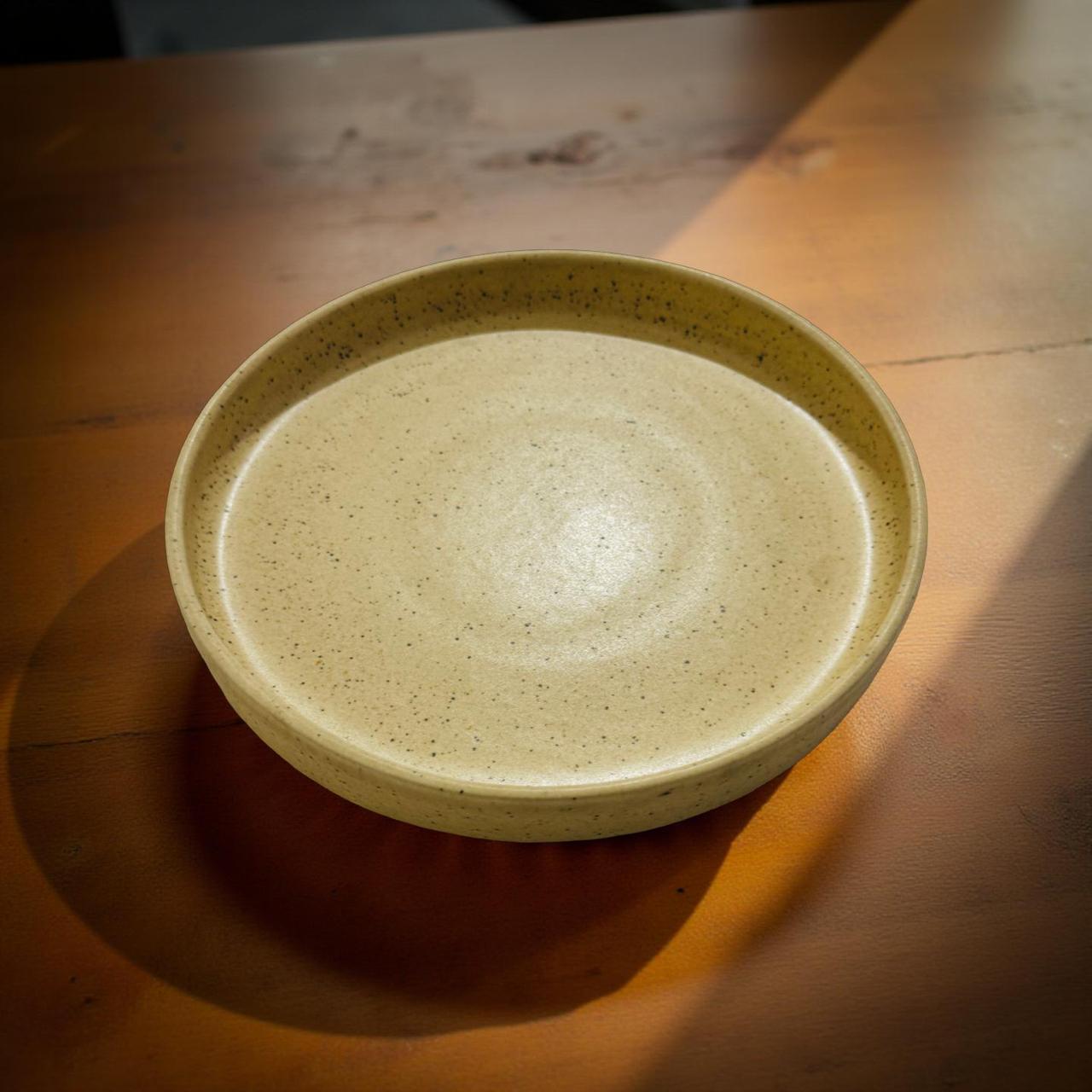Beige ceramic bowl on a wooden surface