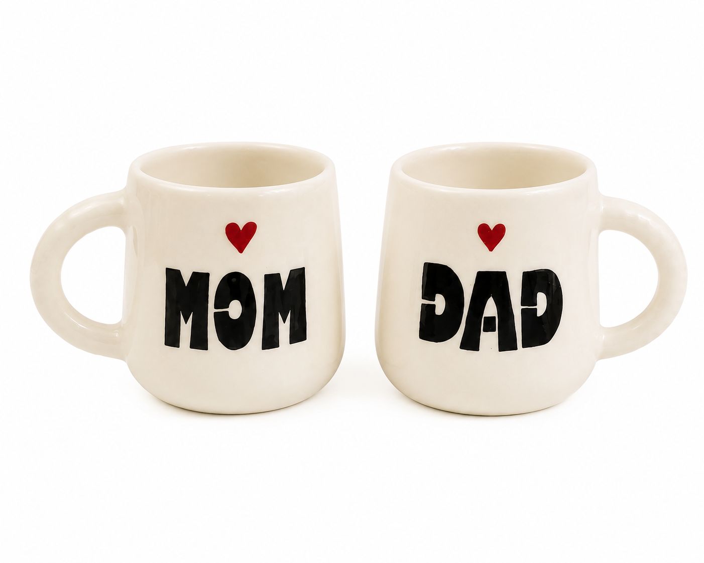 Two cream-colored ceramic mugs with black text reading 'MOM' and 'DAD' and a small red heart above each, shown on a plain white background.