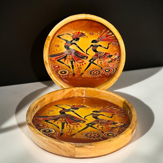 Wooden tray with painted designs of dancers on a white surface