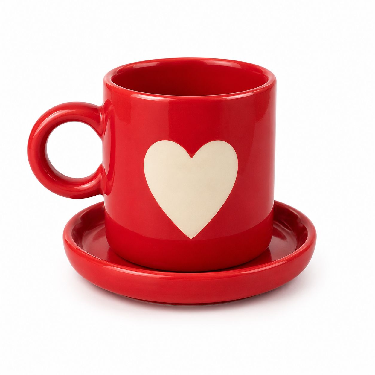 A glossy red ceramic coffee mug with a matching saucer, featuring a large cream-colored heart on the front, set against a plain white background.