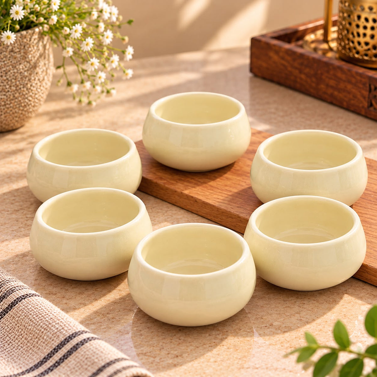 Pastel yellow ceramic dip bowls featuring a smooth finish, ideal for serving chutneys, sauces, nuts and small portions alongside meals.