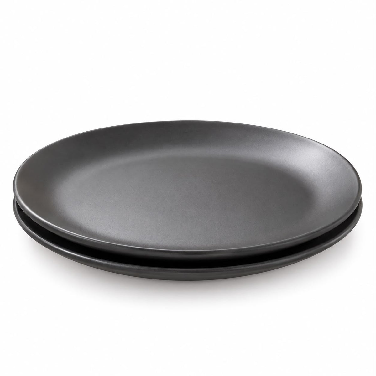 Two matte black ceramic plates stacked on top of each other, photographed on a clean white background.