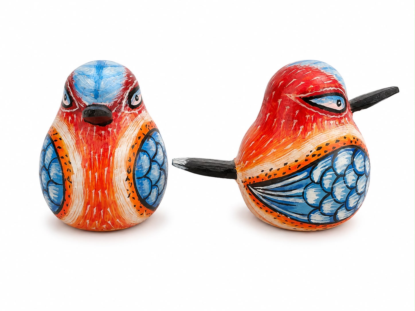 Two hand-painted wooden bird figurines on a white background, one facing forward and the other facing sideways, featuring vibrant red, orange, blue, and white colors with black details.
