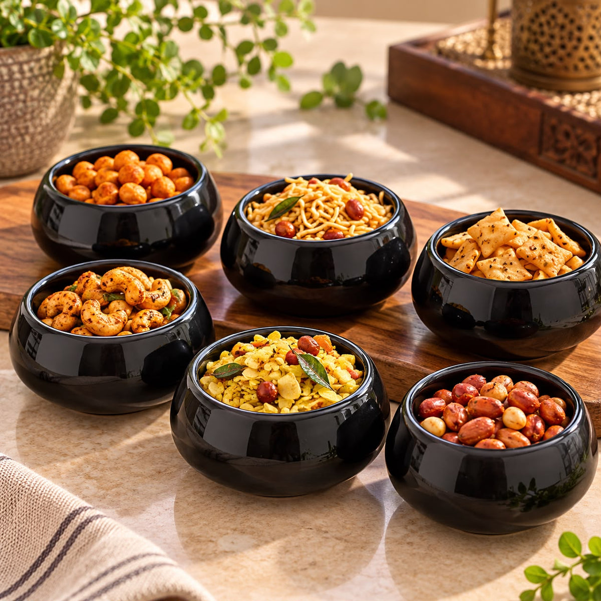 Set of six glossy black ceramic katori bowls arranged on a wooden serving board and beige countertop.