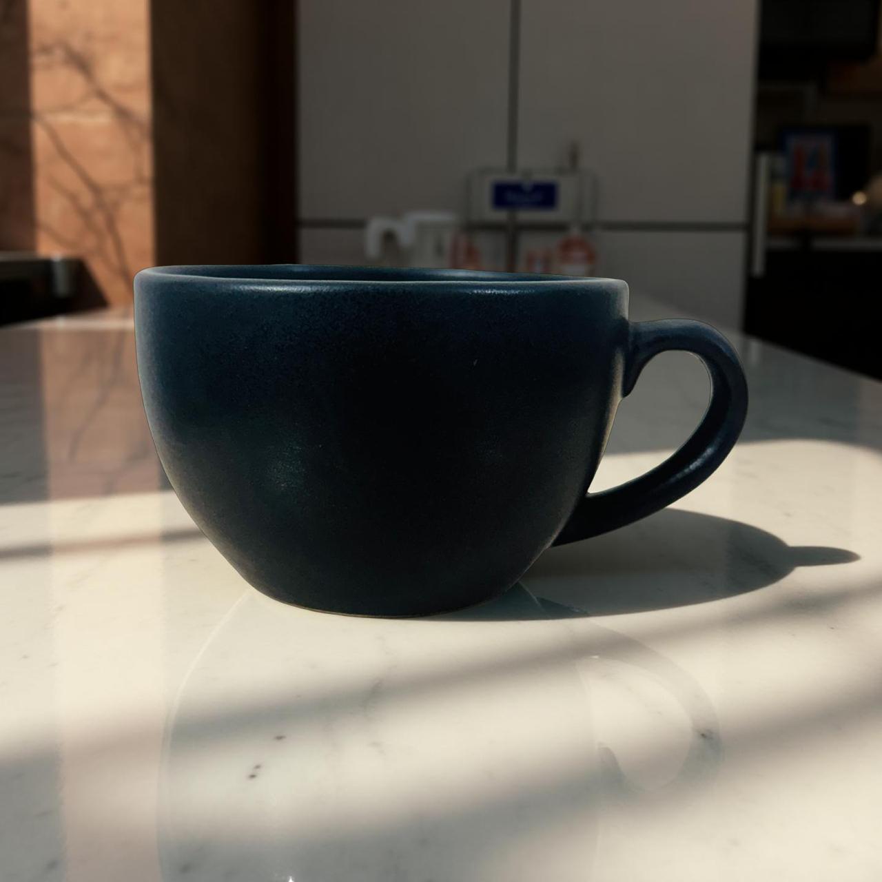 Blue mug on a marble countertop with a blurred kitchen background
